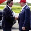 DeSantis Greets Trump at Florida Airport With Novelty Coin Before Fort Myers Rally