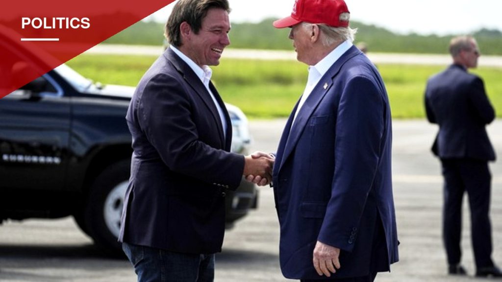 DeSantis Greets Trump at Florida Airport With Novelty Coin Before Fort Myers Rally